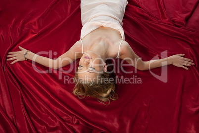 Beauty blond woman with gold hairs on red