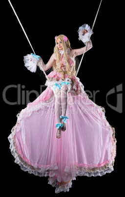 Pretty girl in fary-tale doll costume fly in dark