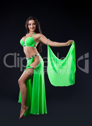 Beautiful young girl stand in green arabic costume