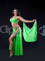 Beautiful young girl stand in green arabic costume