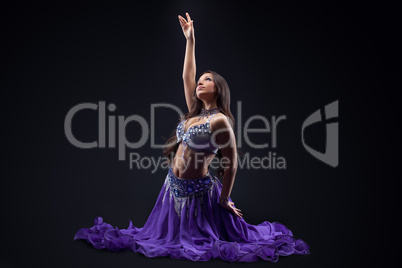 arabia dancer posing in dark - oriental costume