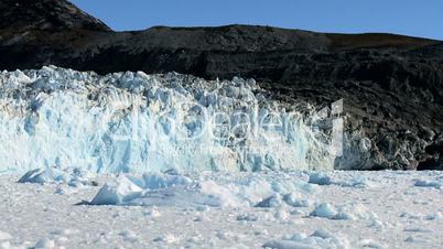 Arctic Glacier Stretching across a Frozen Sea