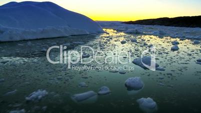Sun setting over a polar iceberg