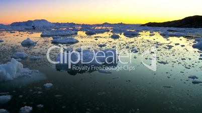 Sun setting over glacier ice