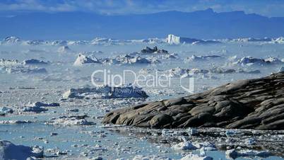 Melting Ice Floes Moving Between Icebergs