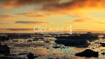 Pan of Golden Sunset over Melting Ice Floes