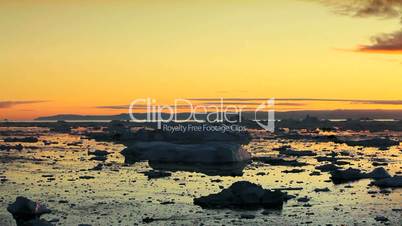 Pan of Golden Sunset over Melting Ice Floes