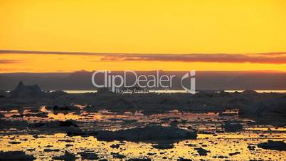 Pan of Golden Sunset over Melting Ice Floes