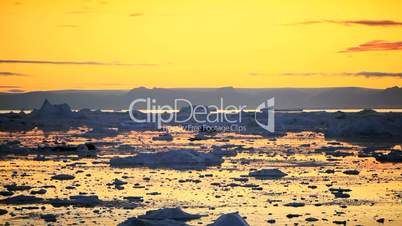 Pan of Golden Sunset over Melting Ice Floes