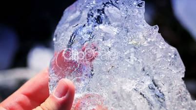 Hands in Close Up Examining Glacial Ice