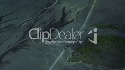 Aerial view of motor traffic driving past flooded river deltas, Iceland