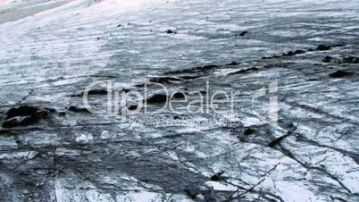 Aerial view of an Ice glacier dusted with black Volcanic ash, Iceland