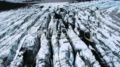 Aerial view of a Arctic glacier blackened by volcanic ash, Iceland