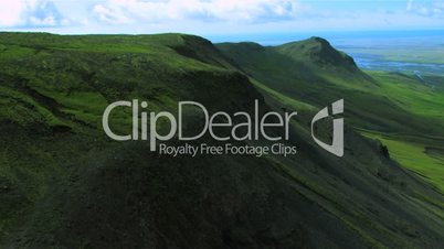 Aerial view of green mountain ridges and fertile plains, Iceland