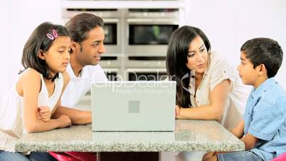 Asian Family in Kitchen with Laptop Computer