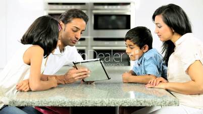 Young Ethnic Family Using Laptop for Webchat