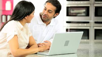 Attractive Asian Couple in Kitchen with Laptop