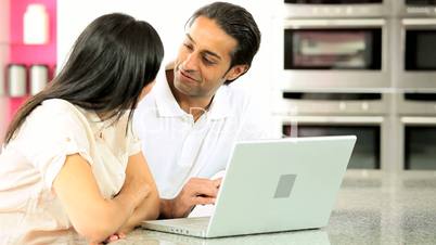 Young Asian Couple Using Laptop Computer