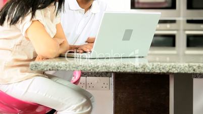 Attractive Young Ethnic Couple Using Laptop