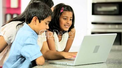 Attractive Asian Mother & Children Using Laptop