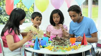 Young Ethnic Family Enjoying Birthday Cake
