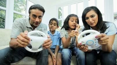 Young Asian Parents Playing on Games Console