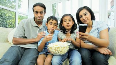 Young Asian family Watching TV with Popcorn