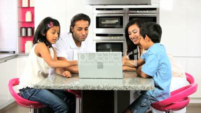 Young Asian Family with Laptop in Kitchen