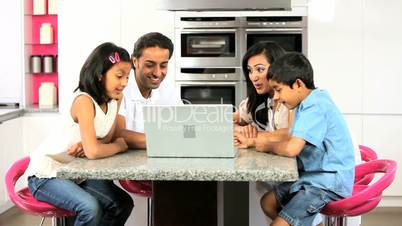 Asian Family in Kitchen with Laptop Computer