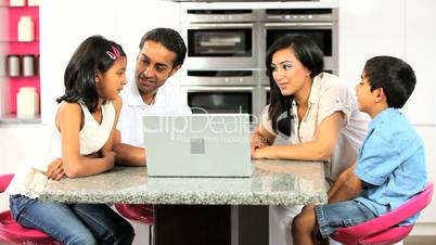 Asian Family in Kitchen with Laptop Computer