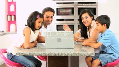 Asian Family Using Online Video Chat with Relatives