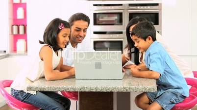Asian Family Using Laptop for Online Video Chat
