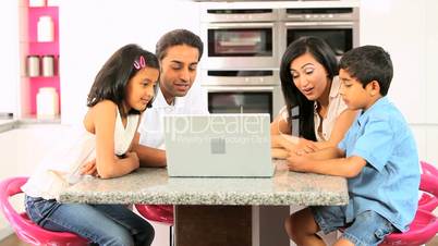 Young Ethnic Family Using Laptop for Webchat