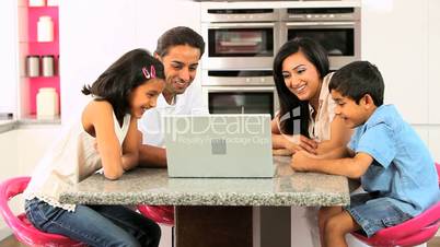 Asian Family Using Online Video Chat with Relatives