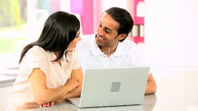 Young Asian Couple Using Laptop Computer