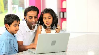 Young Asian Father & Children Using Laptop