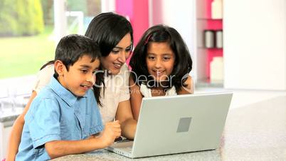 Attractive Asian Mother & Children Using Laptop