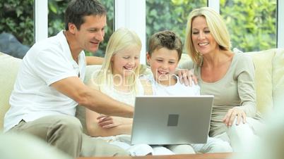 Young Family Using Laptop for Webchat