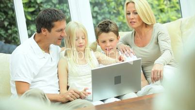 Young Caucasian Family with Laptop Computer
