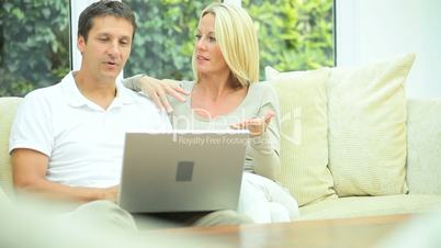 Caucasian Couple Using Home Laptop