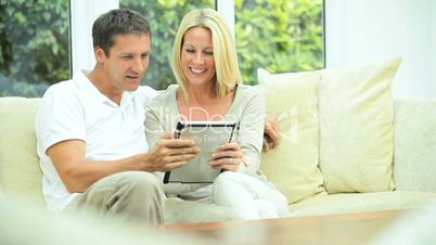 Attractive Caucasian Couple with Wireless Tablet