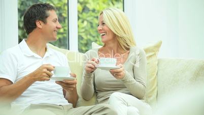 Attractive Couple Relaxing with Cup of Coffee