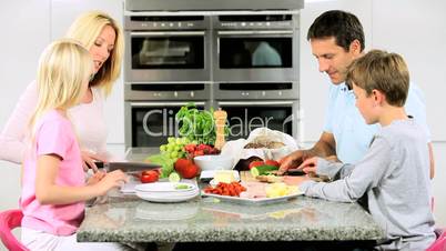 Young Family in Kitchen Preparing Healthy Lunch