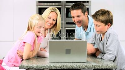 Young Caucasian Family Using Laptop Computer