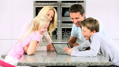 Young Caucasian Family Having Fun with  Wireless Tablet