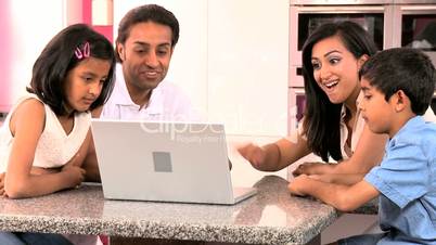 Young Ethnic Family Using Laptop for Webchat