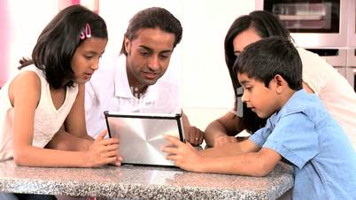 Asian Family Playing on Wireless Tablet