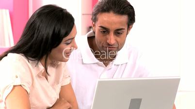 Attractive Asian Couple in Kitchen with Laptop