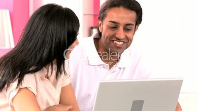 Young Asian Couple Using Laptop Computer