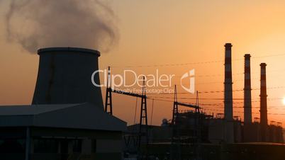 Power plant smokestacks at sunset